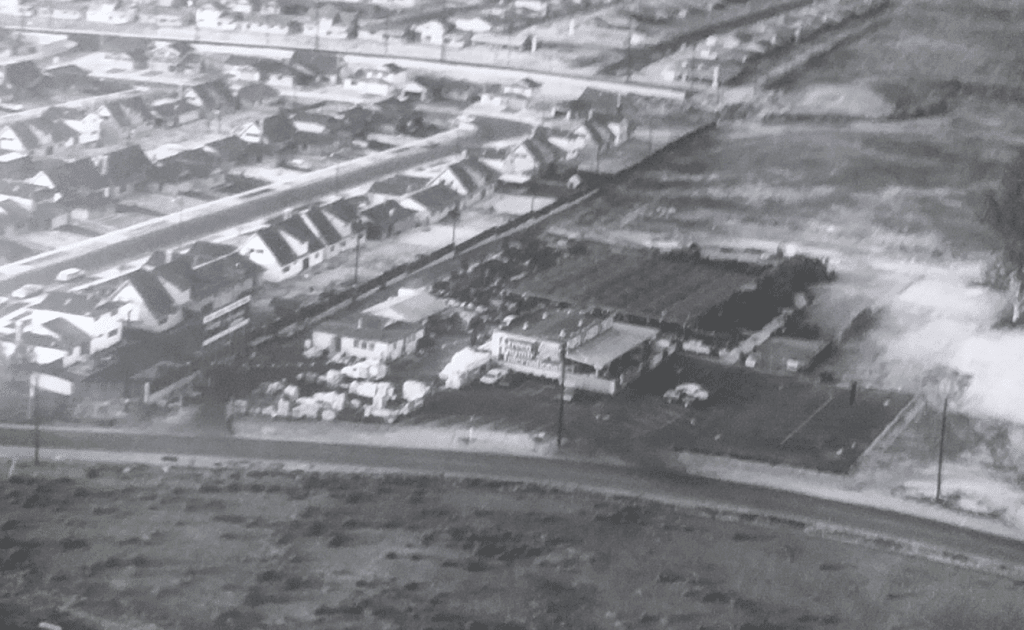 A black and white photo of an aerial view of a town.