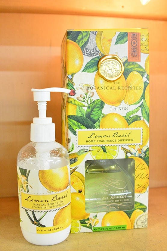 A bottle of hand soap next to a box of lemons.
