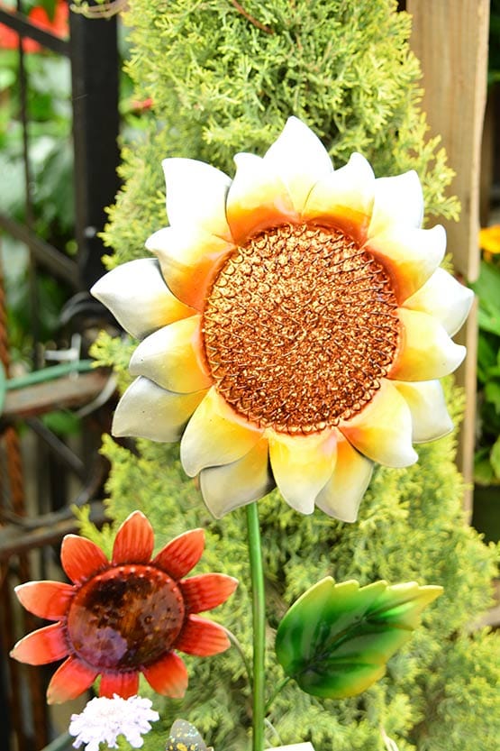A flower pot with a sunflower on it.