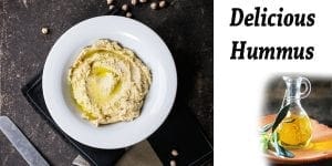 Delicious hummus served on a plate with a bottle of olive oil at the best garden center near me.