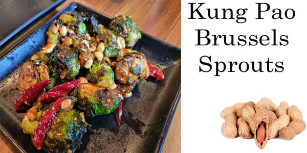 Kung pao brussels sprouts on a black plate at the best garden center near me.