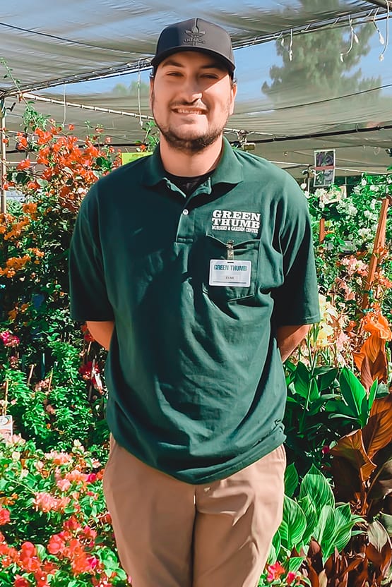A man standing in a greenhouse.