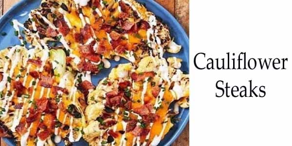 Cauliflower steaks plated on a blue dish.