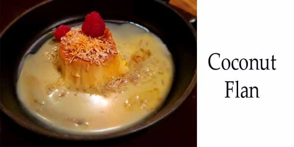 Coconut flan in a pan with raspberries from the best garden center near me.