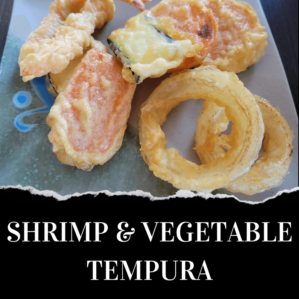 A plate with shrimp and assorted vegetable tempura, including onion rings, zucchini, and sweet potato, on a blue and white dish.