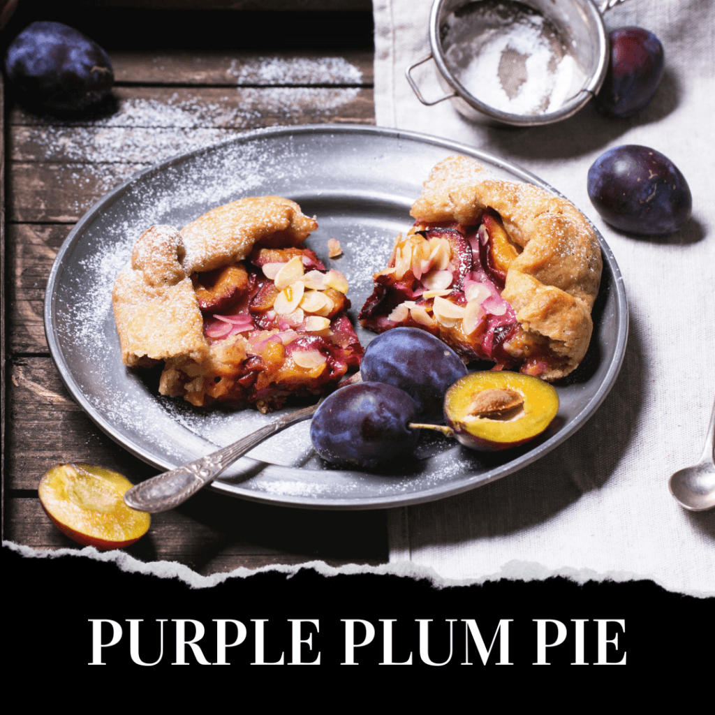 A rustic purple plum pie topped with sliced almonds is served on a gray plate with fresh plums and a spoon, set on a wooden table dusted with powdered sugar.