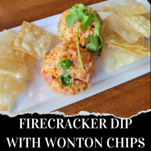 Two scoops of firecracker dip garnished with cilantro served on a rectangular plate with crispy wonton chips on a wooden table.