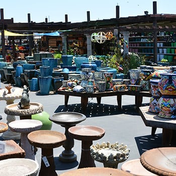 A large outdoor market with a variety of pots and vases.
