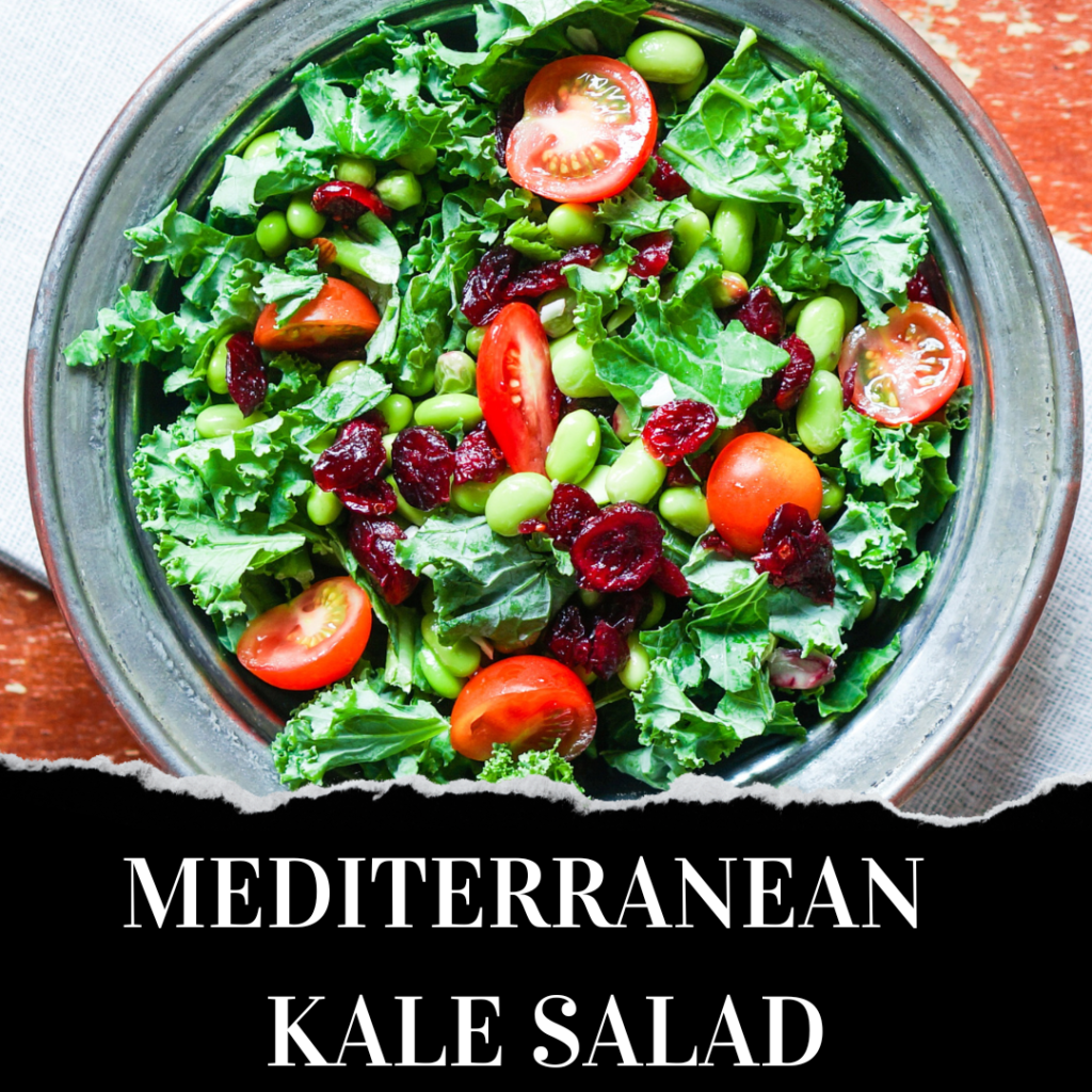 A bowl of Mediterranean kale salad with cherry tomatoes, edamame, dried cranberries, and fresh kale on a wooden surface.