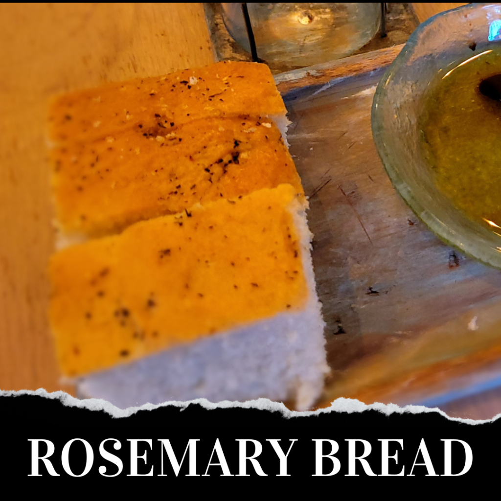 Rosemary bread on a wooden cutting board.