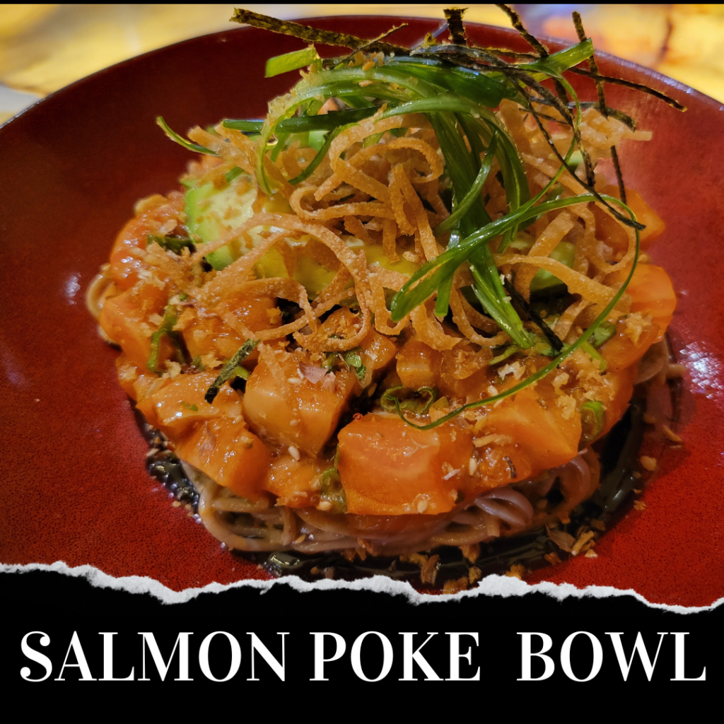 A salmon poke bowl on a red plate.