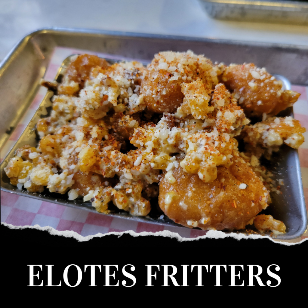 A tray of elotes fritters topped with crumbled cheese and seasoning. The text "ELOTES FRITTERS" is written below the image.