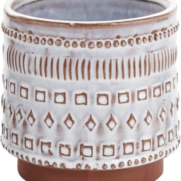 A ceramic planter with a geometric pattern in white and brown tones.