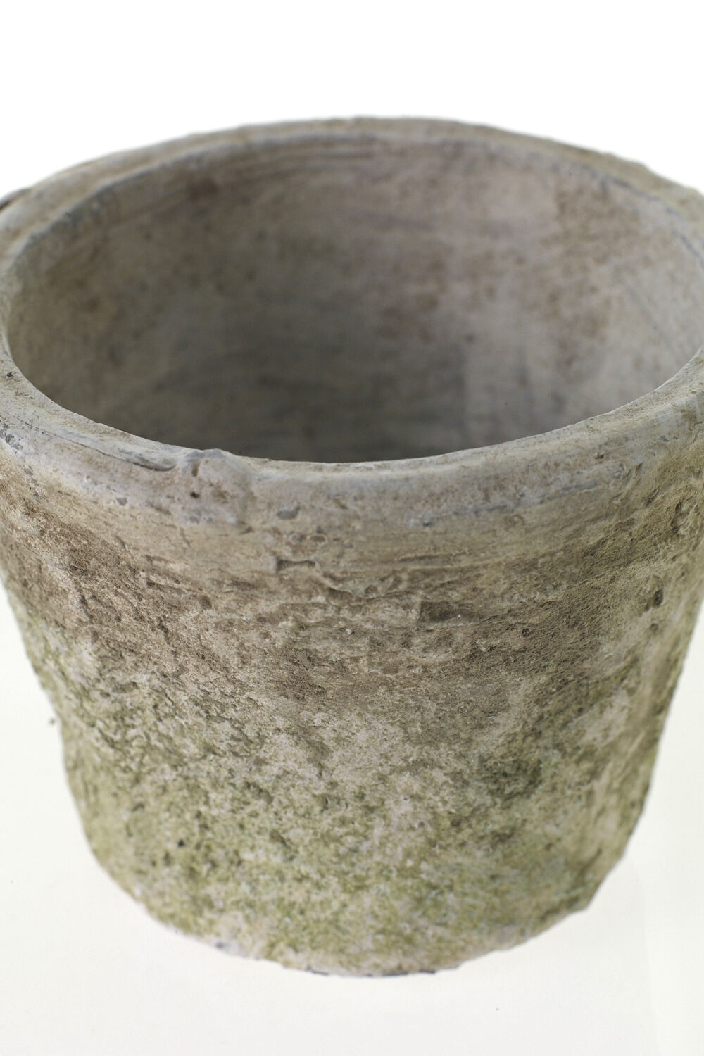 A weathered, moss-covered stone pot with a rough texture and rounded shape, viewed from above against a white background.