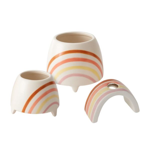 Three ceramic planters with pastel rainbow designs, each supported by small legs. One is arch-shaped, the others are pot-shaped.