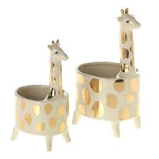 Two ceramic planter pots shaped like giraffes, featuring gold spots and elongated necks.