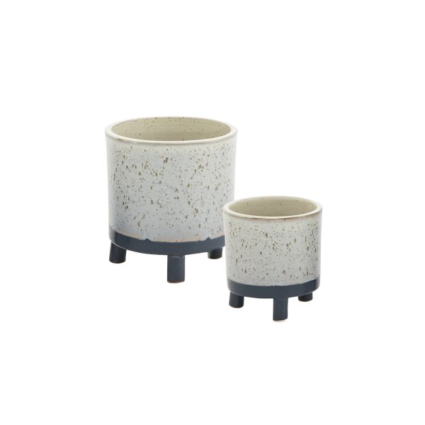 Two ceramic planters with legs, one larger and one smaller, featuring a speckled white finish and dark bases.