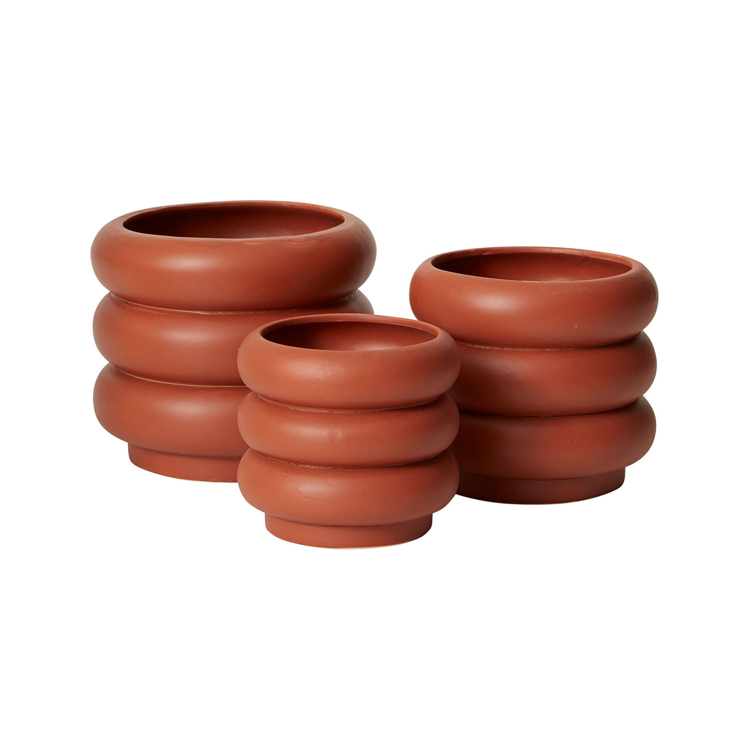 Three stacked terracotta pots of varying sizes arranged in a group.