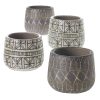 Four ceramic pots with geometric designs in earthy tones, arranged in two rows.